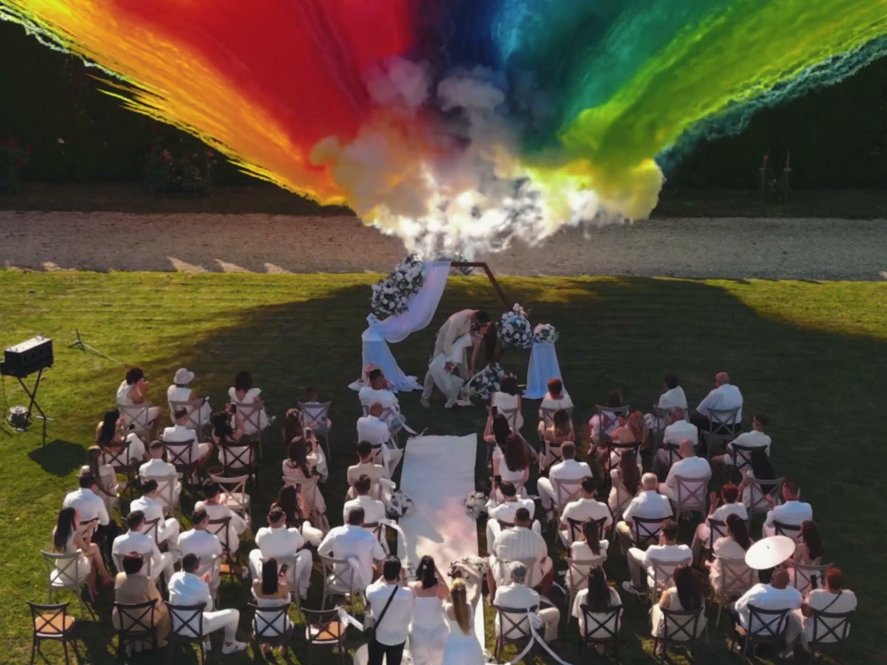 A wedding ceremony under a burst of coloured powder, delivered at full 4K quality.